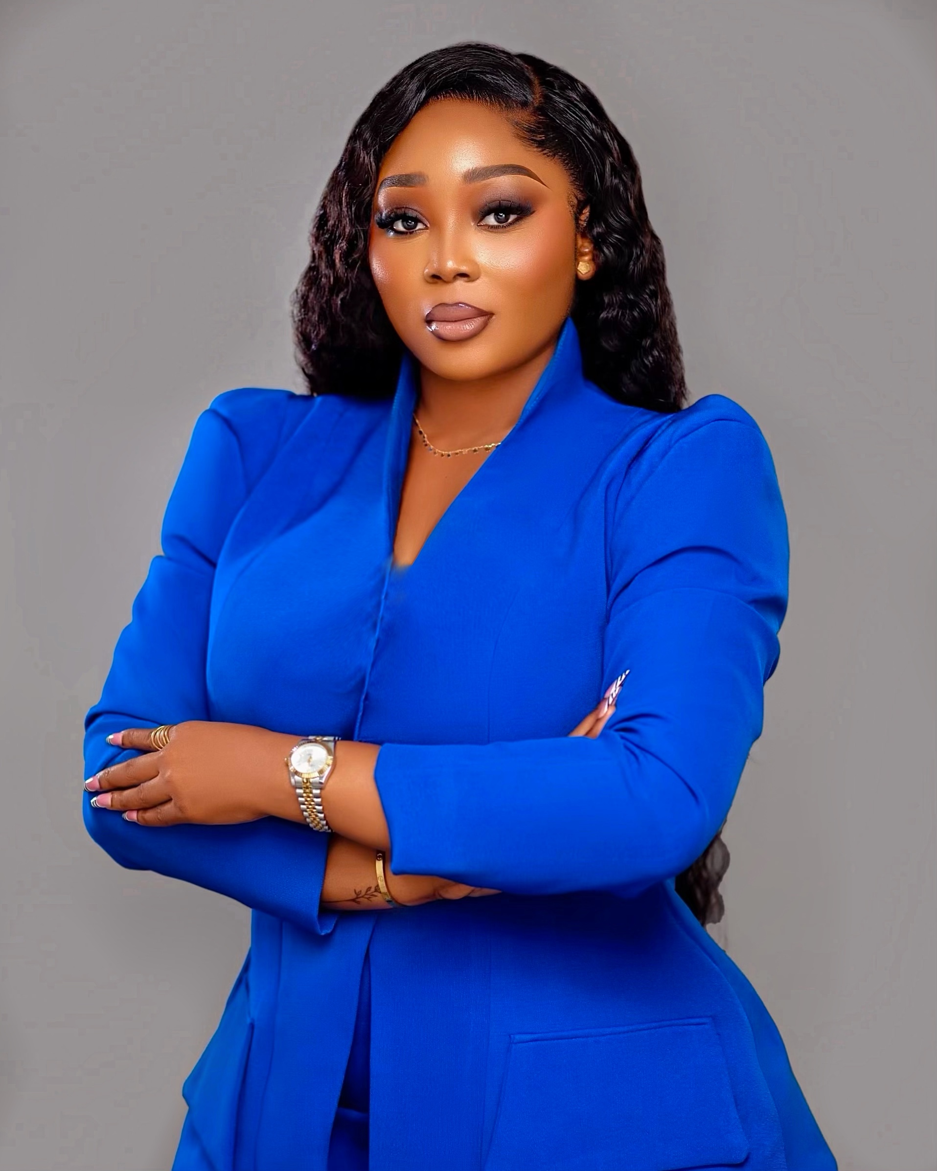 Perkins Ogedengbe, Vice President of Sales, in a royal blue blazer with arms folded